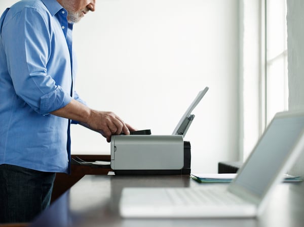 A man working on a home office printer