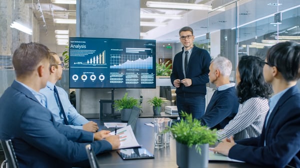 A business man makes a presentation with a smart white board.